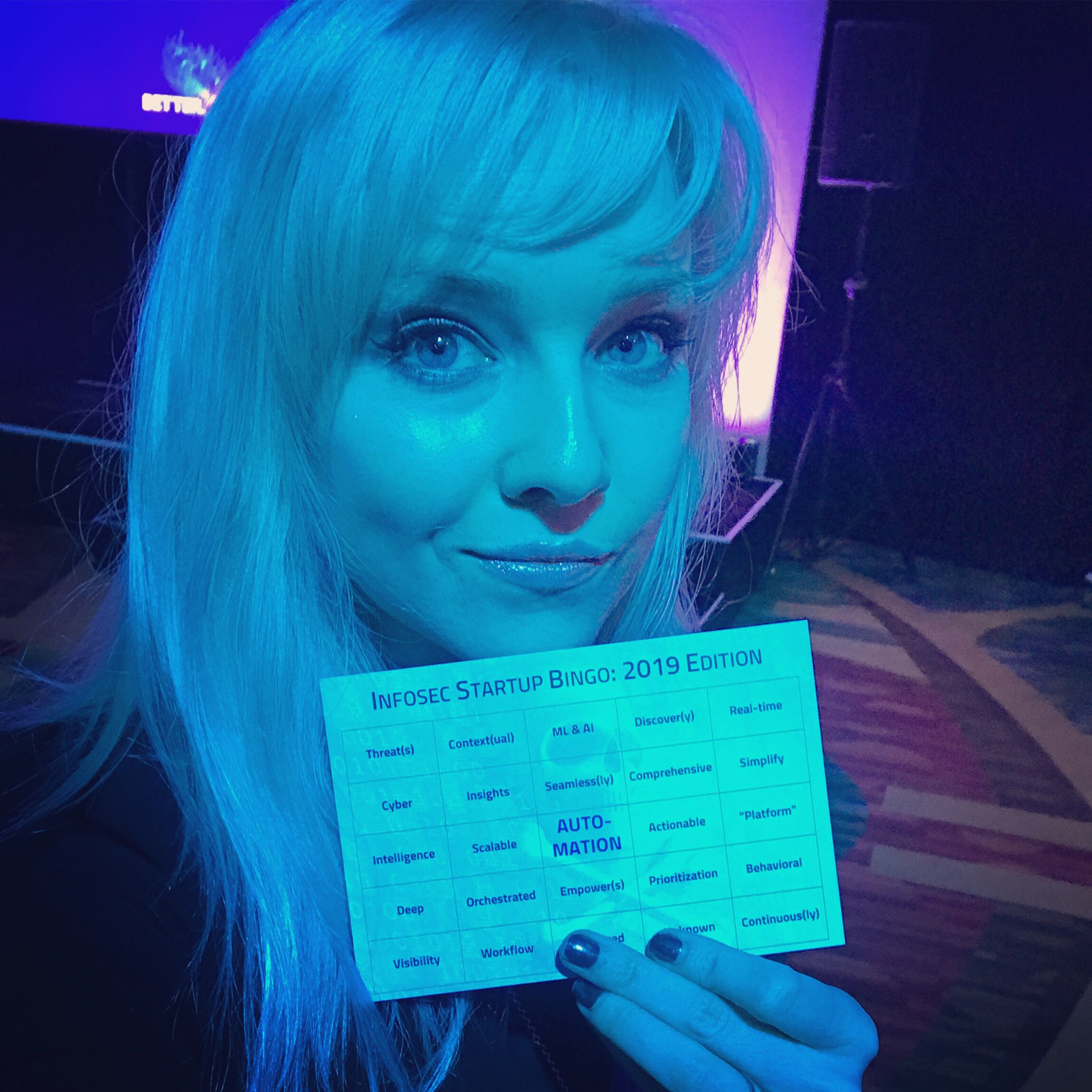 Kelly Shortridge holding their infosec buzzword bingo card